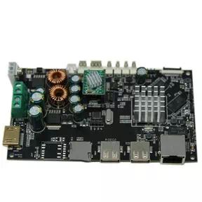 Black single-board computer motherboard with USB ports, Ethernet, HDMI, memory chips, and various capacitors and inductors.